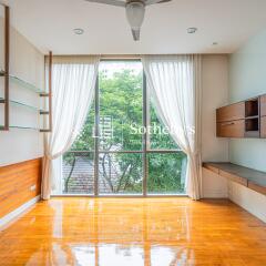 Bright living room with large windows and built-in shelves and drawers