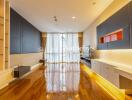 Modern living room with wooden floors, large window with curtains, built-in cabinets and shelves, and stylish lighting