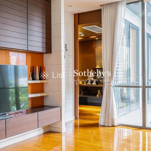 Modern living area with TV and decorative shelves near a large window