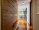 Modern hallway with wooden wall paneling and polished floor