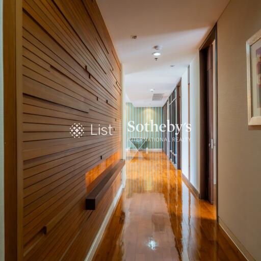 Modern hallway with wooden wall paneling and polished floor