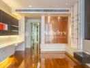 Modern living room with wooden floor, built-in shelves, and recessed lighting