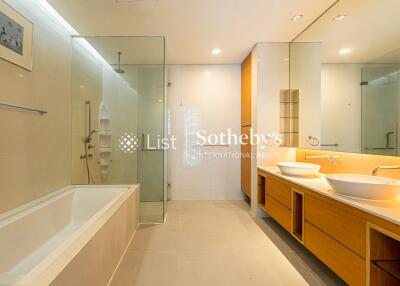 Modern and spacious bathroom with glass shower and dual sinks