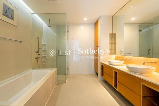 Modern and spacious bathroom with glass shower and dual sinks