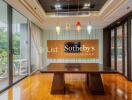 Conference room with a wooden table, glass doors, and decorative light fixtures