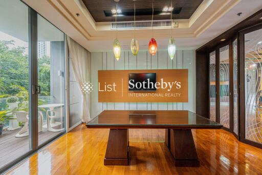 Conference room with a wooden table, glass doors, and decorative light fixtures