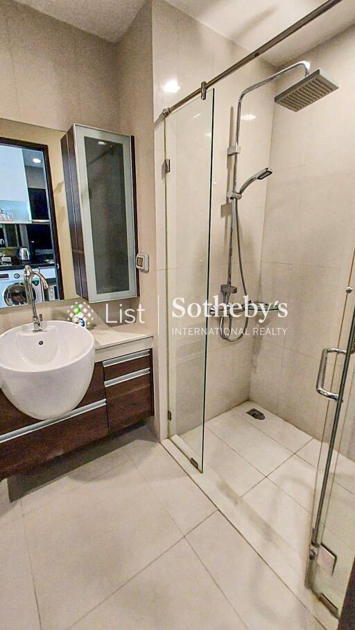 Modern bathroom with glass-enclosed shower and vanity with mirror