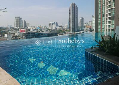 High-rise building with rooftop infinity pool and city view