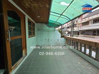 Spacious balcony with tiled floor and partial roof covering