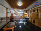 Living room with wooden cabinetry, staircase, sofa, and dining area