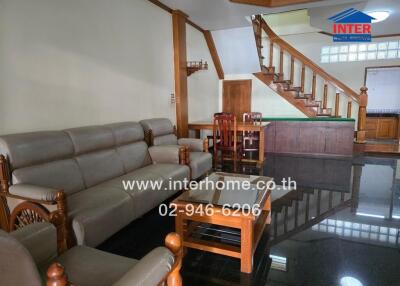 Living room with wooden staircase and furniture