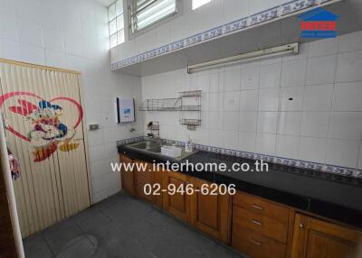 Clean kitchen area with counter, sink, and storage space