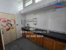 Clean kitchen area with counter, sink, and storage space