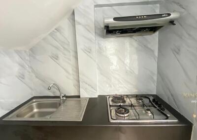 Modern kitchen with stainless steel sink and gas stove