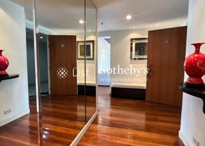 Spacious hallway with wooden flooring and decorative vases