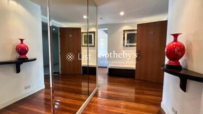 Spacious hallway with wooden flooring and decorative vases