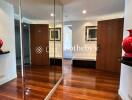 Spacious hallway with wooden flooring and decorative vases