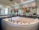 Modern bathroom with large bathtub and decorative flowers