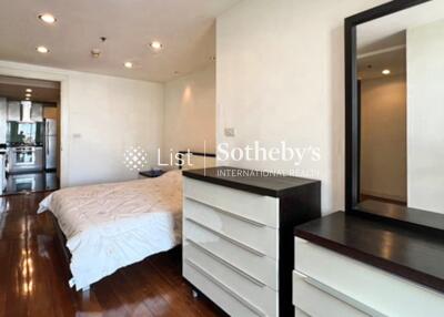 Modern bedroom with wooden flooring and white furniture