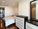 Modern bedroom with wooden flooring and white furniture