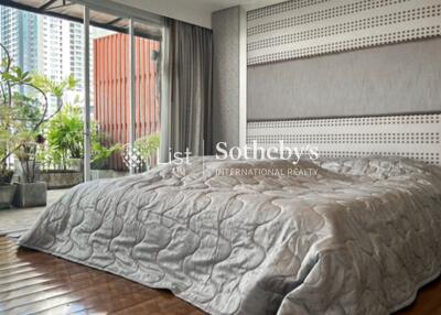 Modern bedroom with a large window and patio view