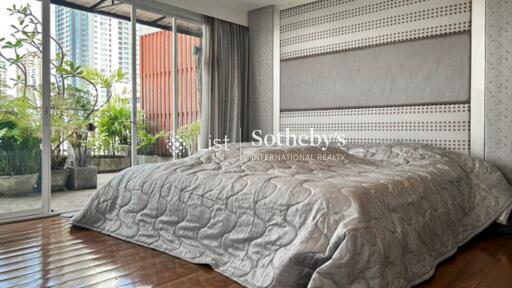 Modern bedroom with a large window and patio view