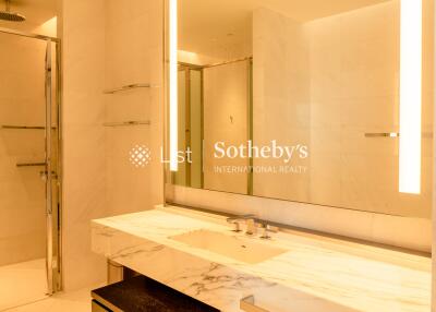 Modern bathroom with marble countertop and large mirror