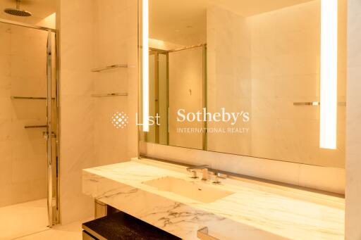 Modern bathroom with marble countertop and large mirror