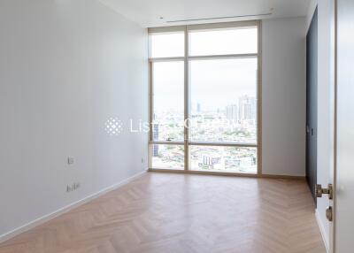 Bright bedroom with large floor-to-ceiling window