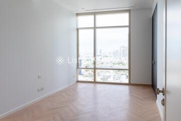 Bright bedroom with large floor-to-ceiling window