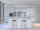 Modern kitchen with marble island and stools