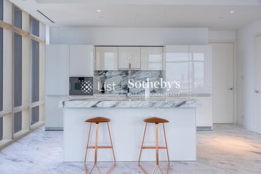 Modern kitchen with marble island and stools