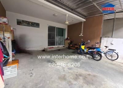 Garage space with shelves, bicycles, and a scooter