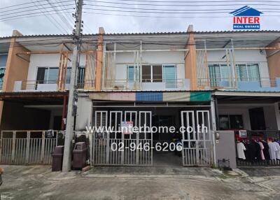 Two-story townhouse exterior with gated entrance