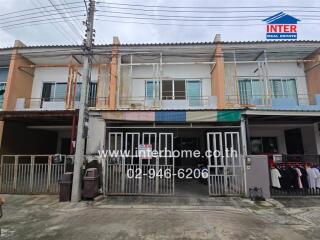 Two-story townhouse exterior with gated entrance