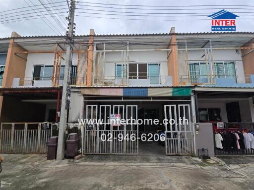 Two-story townhouse exterior with gated entrance