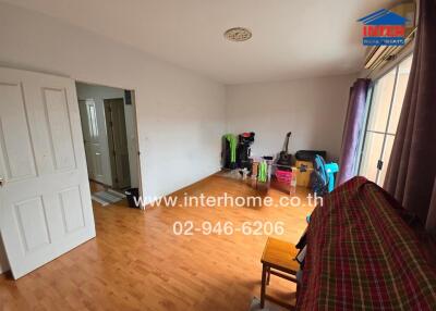 Living room with wooden flooring and large window