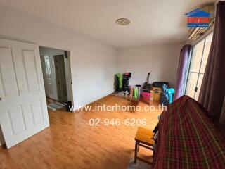 Living room with wooden flooring and large window