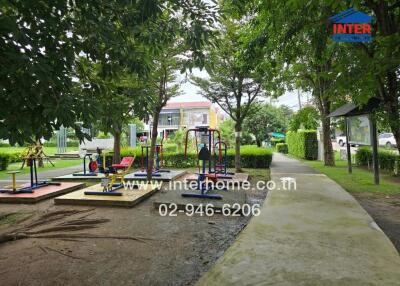 Outdoor exercise area in a park with fitness equipment and walkways