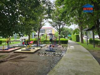 Outdoor exercise area in a park with fitness equipment and walkways