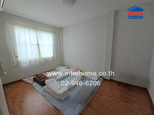 Bedroom with floor mattress and window