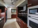 Modern kitchen with wooden cabinetry and stainless steel appliances