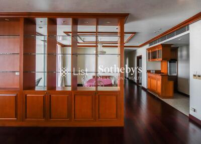 Spacious living area with wooden shelving and high-quality hardwood flooring