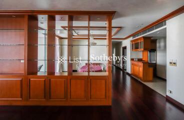 Spacious living area with wooden shelving and high-quality hardwood flooring