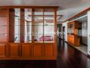 Spacious living area with wooden shelving and high-quality hardwood flooring