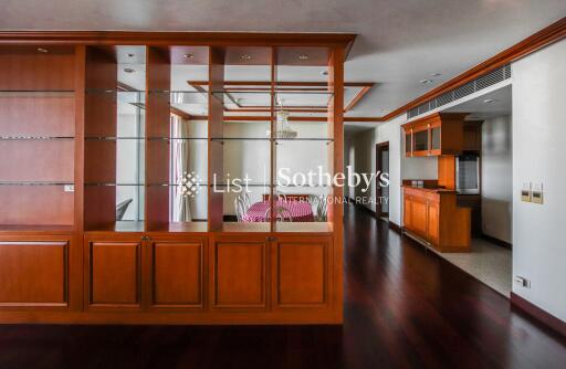 Spacious living area with wooden shelving and high-quality hardwood flooring