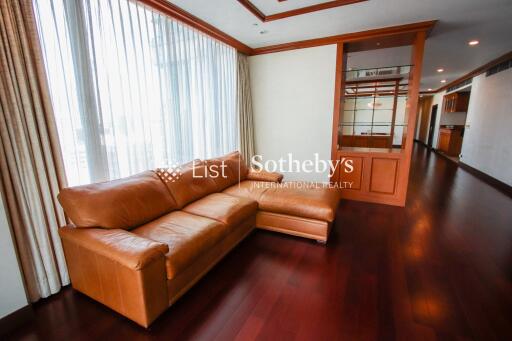 Spacious living room with large windows and leather sofa