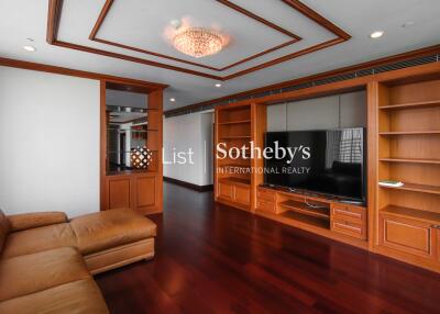 Spacious living room with wooden built-in storage and TV unit