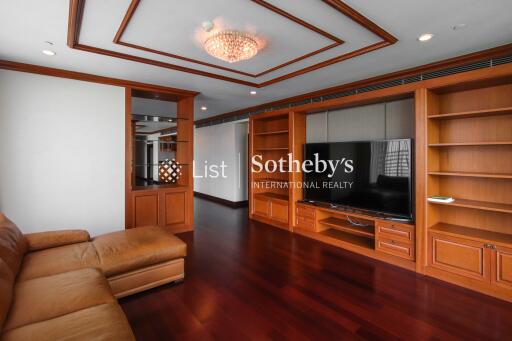 Spacious living room with wooden built-in storage and TV unit