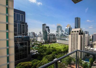 View from balcony overlooking cityscape with greenery